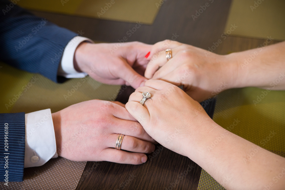 A couple holding hands each other on date. Crop on hands A couple holding hands each other on date. Crop on hands