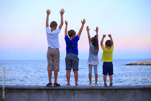 Foto Four children on beach vocation