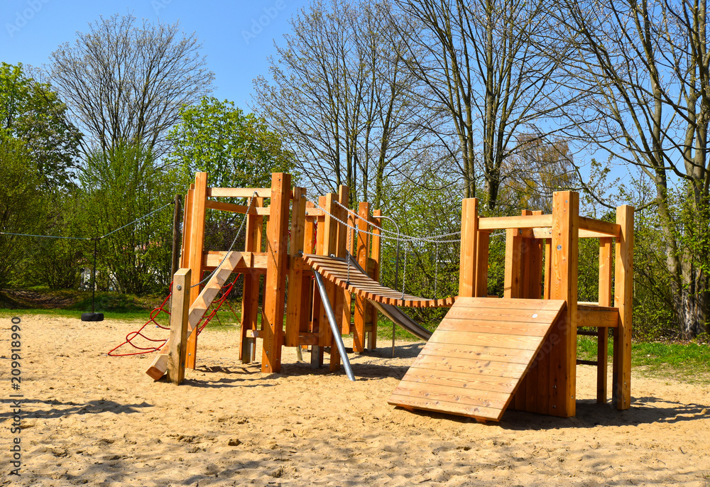 Sand with various wooden playground equipment on a public playground in Berlin Sand with various wooden playground equipment on a public playground in Berlin