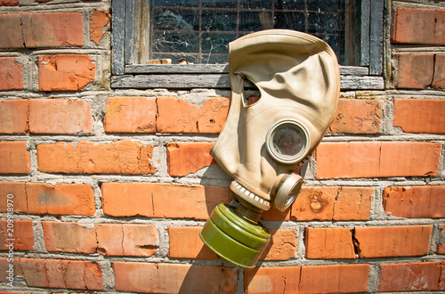gas mask (window, brick wall)