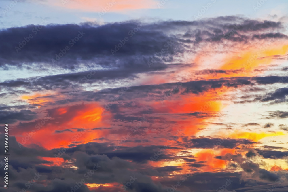 Layered forms of beautiful clouds with red sunset.