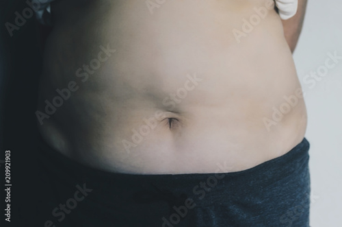 Human body and fat body part of paunch or belly and overweight of people.