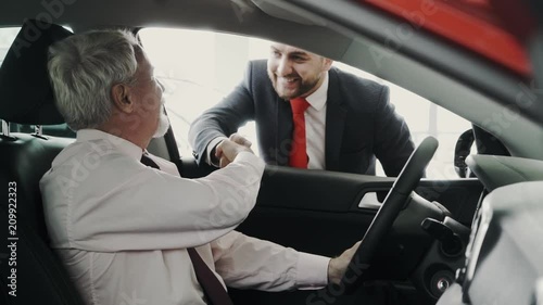 Business men. Handshake through the car window. Very professional. Looking representive. photo