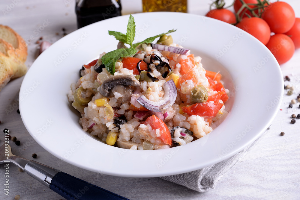 Rice salad with vegetables on white plate
Rice salad with vegetables on white plate