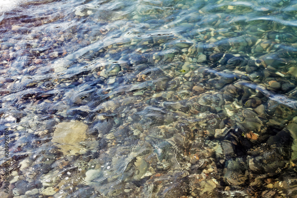 Sea stones in the water of Black Sea. Sochi.