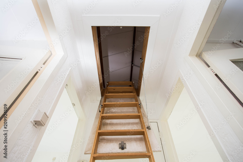 Wooden staircase to the attic in a modern house Wooden staircase to the attic in a modern house