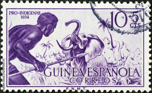 African native hunter and elephant on vintage stamp