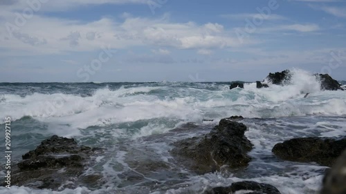 Sparkling ocean waves with rock, waves splashing against coastal rock, waves smashing foam rocky, ocean background