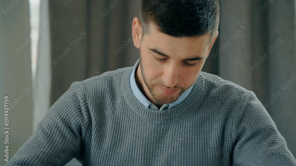 Portrait of young man drawing lines with pencil in the office. Concept: business people, papaer work, drawing lines, pencil hand.
