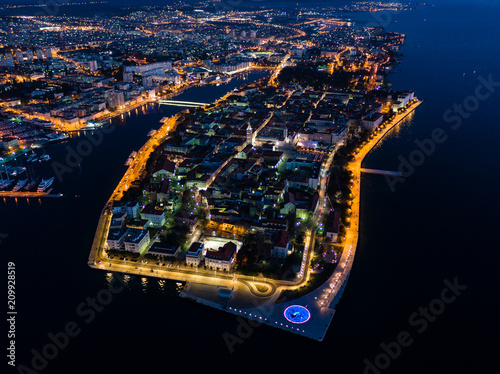 Aerial view of Zadar peninsula at night with beautiful lights and Adriatic sea, Croatia, drone photo