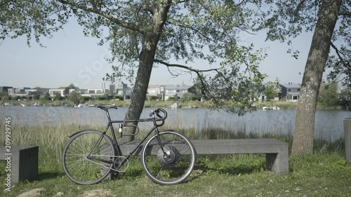 Concrete Bench with E-Bike and Modern Villas in the Background photo