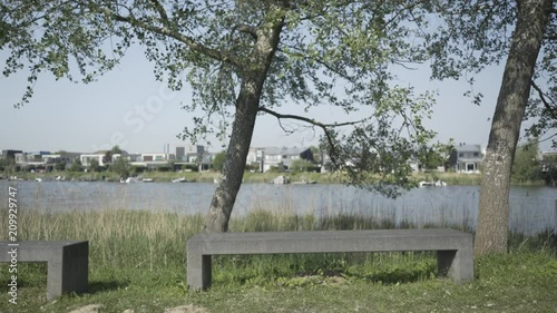 Concrete Bench with Water and Modern Villas in the Background photo