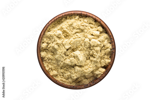 Fototapeta Naklejka Na Ścianę i Meble -  cardamom powder spice in wooden bowl, isolated on white background. Seasoning top view