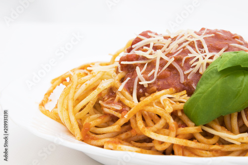 spaguetis a la bolognese dish with cheese and basil leaf