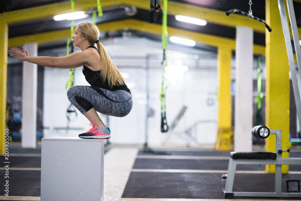 woman working out jumping on fit box woman working out jumping on fit box