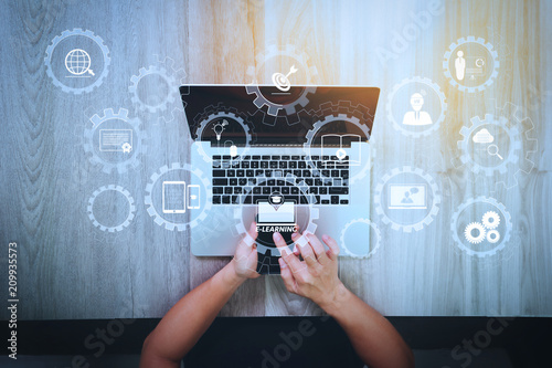 top view of Designer hand working with smart phone and laptop computer on wooden desk as responsive web design concept