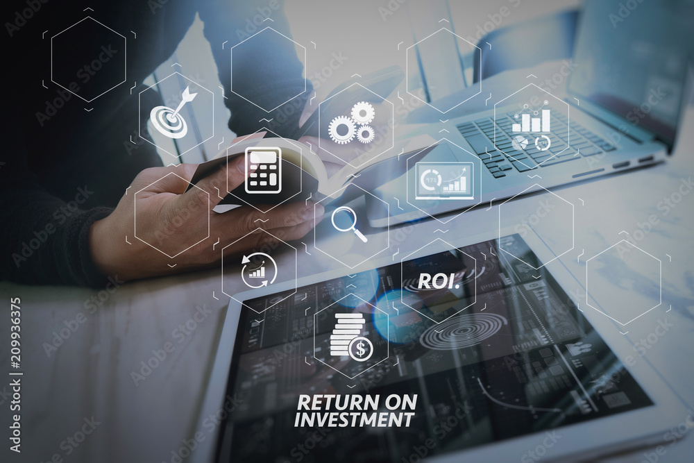 Fototapeta premium Businessman hand holding book and digital tablet.Photo finance manager working new Investment project office.Using new technology device.Graphic icons.Strategy business stock exchanges