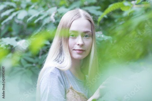 Fototapeta Naklejka Na Ścianę i Meble -  Portrait of young blonde girl in the garden
