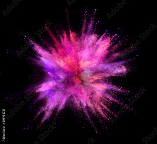 Explosion of coloured powder isolated on black background. Freeze motion of abstract colors shape in sphere shape