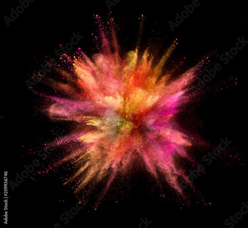 Explosion of coloured powder isolated on black background. Freeze motion of abstract colors shape in sphere shape