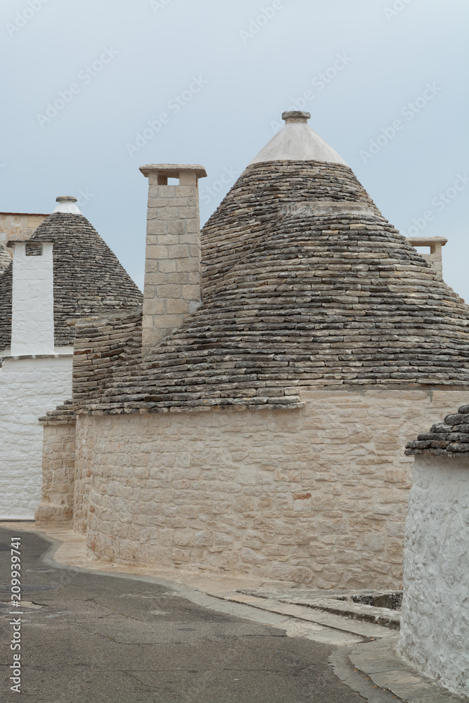 Unique small South Italia city Alberobello with antient stones conical houses trullo, tourist destination