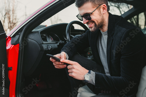 Young handsome man using phone , rich guy sitting in the car © evgeniy_regulyan