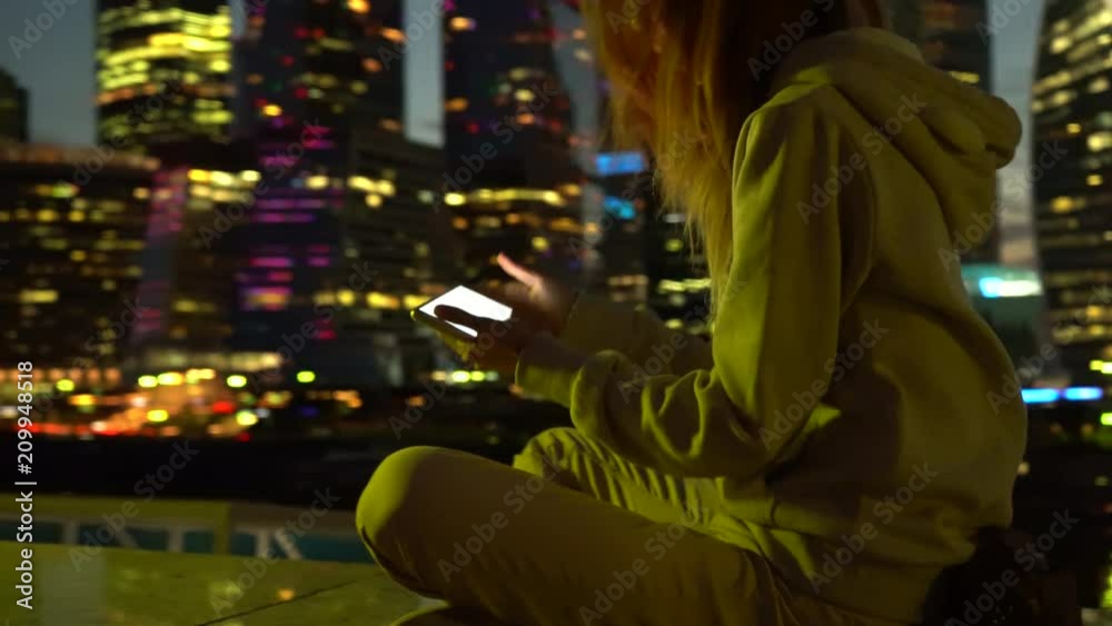 Girl at night with a smartphone on the Internet Girl at night with a smartphone on the Internet