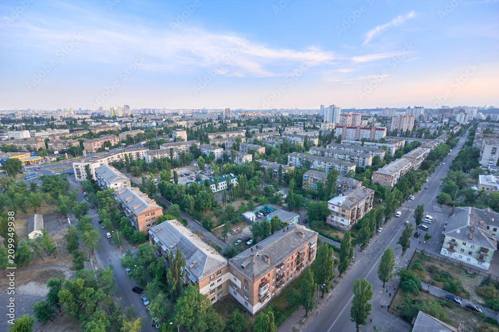 Aerial View of residential district in wonderful summer evening.View over the city rooftops with sunlight and foliage.Moderns buildings at Industrial uptown,residential neighbourhood