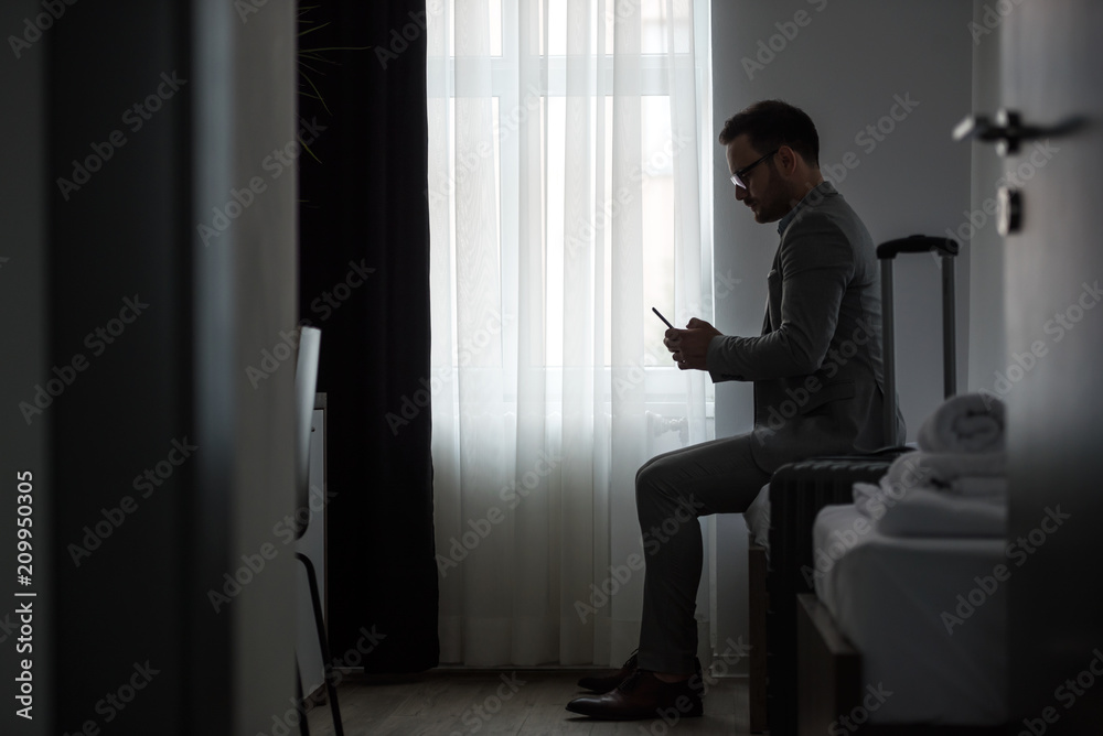 Businessman using smart phone at hotel room Businessman using smart phone at hotel room