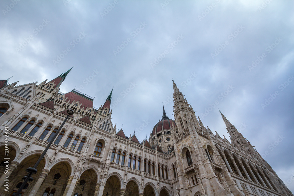 Hungarian Parliament (Orszaghaz) in Budapest, capital city of Hungary, taken during a cloudy afternoon. The Parliament, of a gothic style, is an iconic landmark of the city.