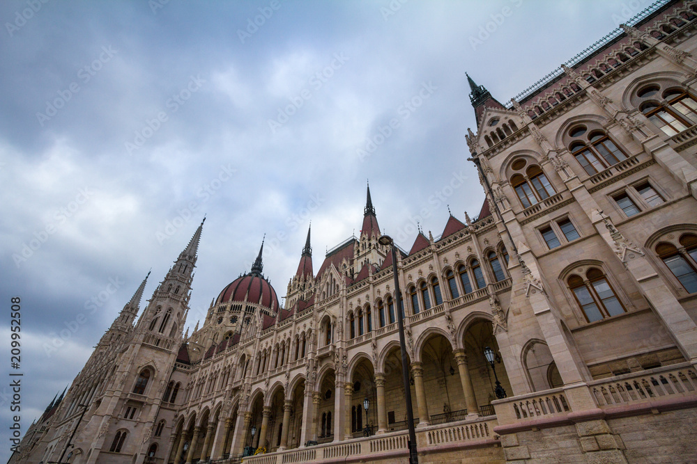 Hungarian Parliament (Orszaghaz) in Budapest, capital city of Hungary, taken during a cloudy afternoon. The Parliament, of a gothic style, is an iconic landmark of the city