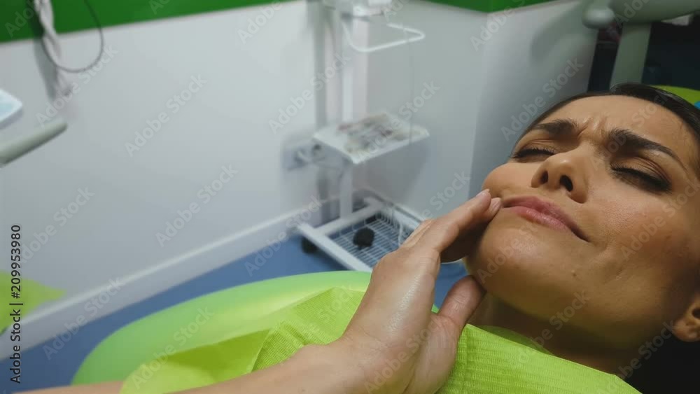 Woman feels toothache, waiting for doctor in dentist chair, pain reliever Woman feels toothache, waiting for doctor in dentist chair, pain reliever