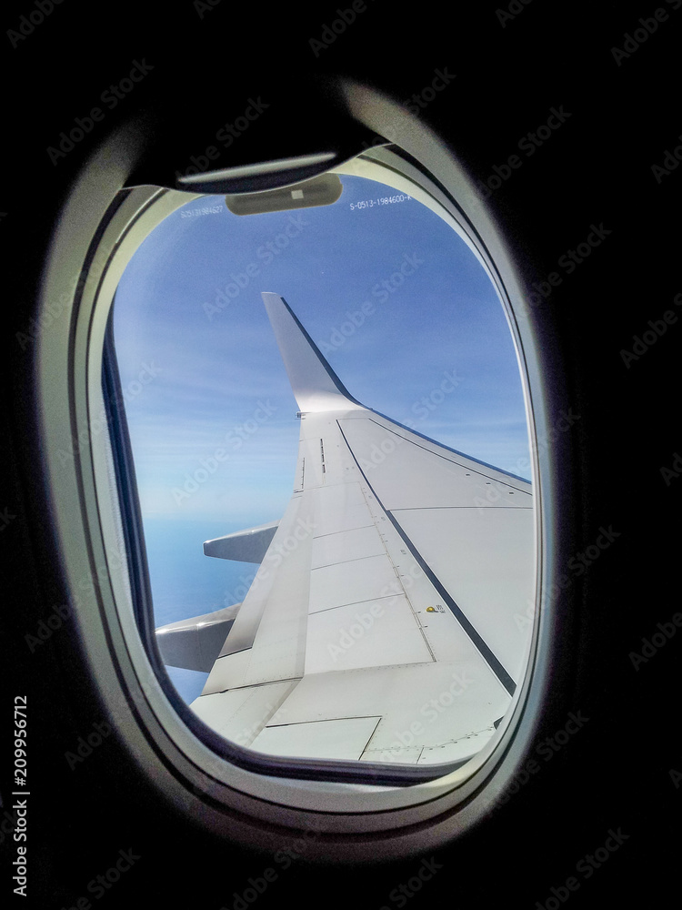 Wing through a jet airliner window Wing through a jet airliner window