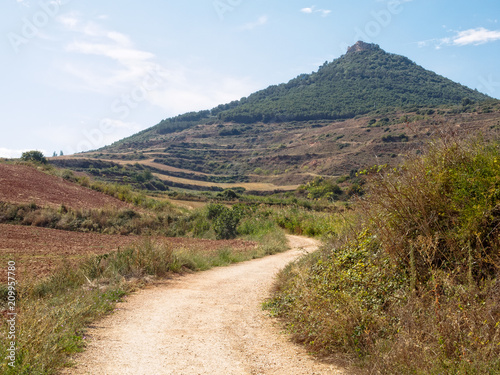 The conical peak of Monjardin with the ruins of the St. Stepen's Castle (Castillo de San Esteban de Deyo) on top of it - Villamayor de Monjardin, Navarre, Spain