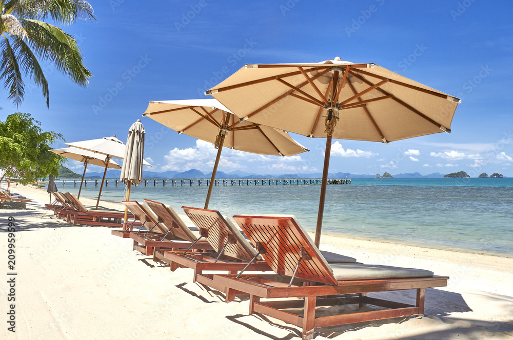 Sun beds and umbrellas on a beautiful beach on the background of the sea
Sun beds and umbrellas on a beautiful beach on the background of the sea