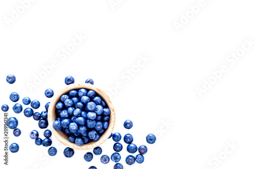 Fresh recently picked blueberries in bowl on white background top view copy space