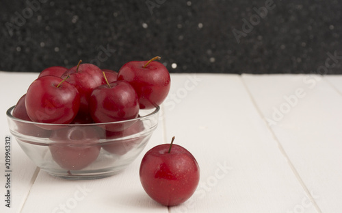 Fresh red plums, on white background. 