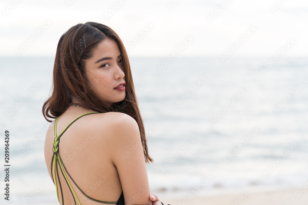 Asian beautiful woman enjoyful on the beach background.