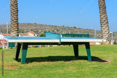 Tabletennis or ping pong table in the city park outdoor at sunny day. photo