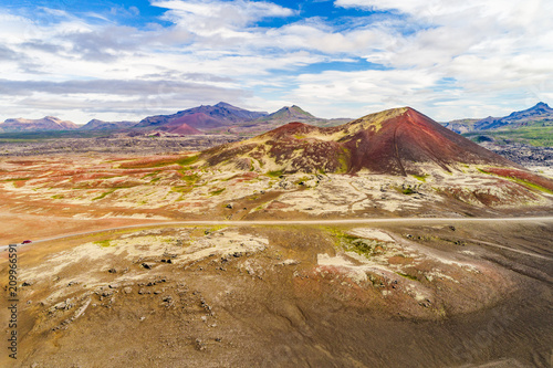 Aerial view of Iceland mountain desert landscape for vacation concept. Road trip travel car crossing through lava rocks volcanic mountains, nature background in Iceland. Travel adventure.