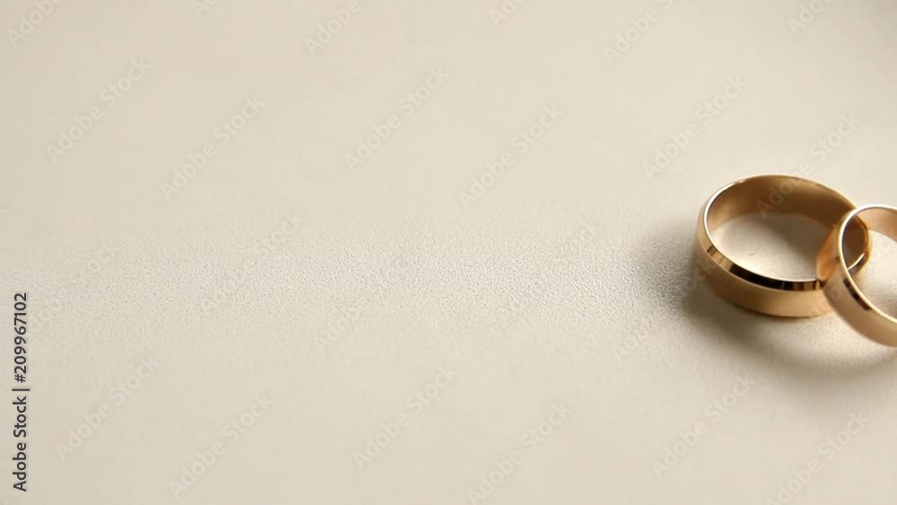 two wedding rings on a white background, moving camera two wedding rings on a white background, moving camera