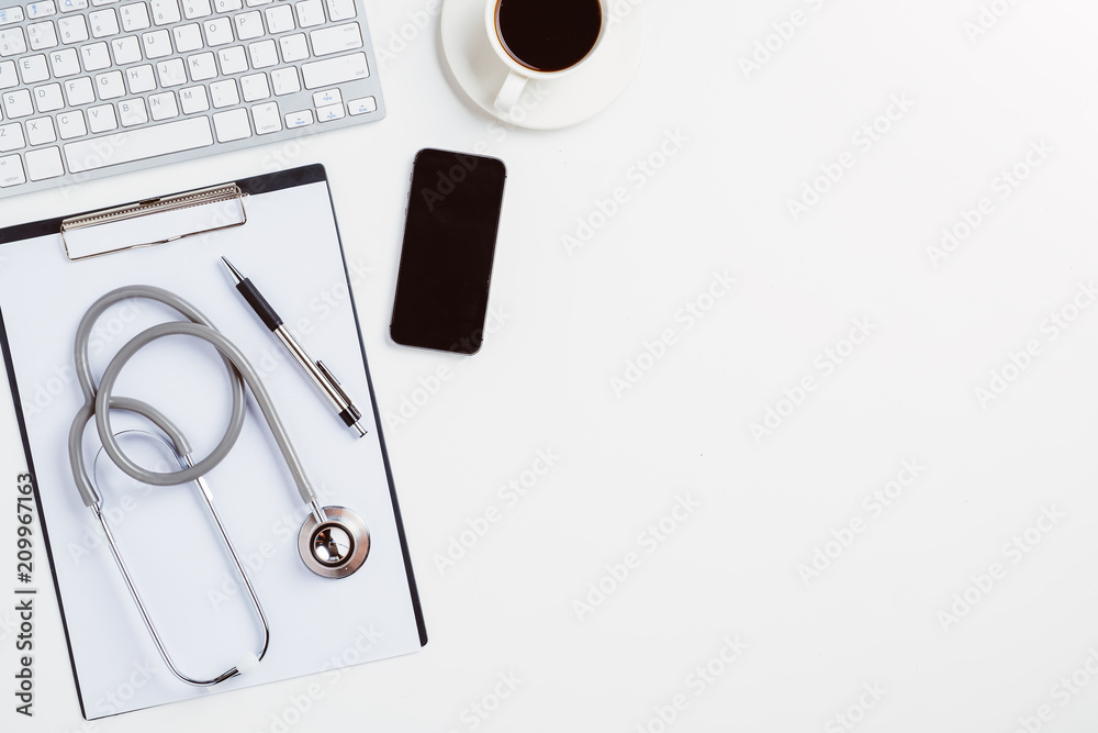 Medical desk with stethoscope,heart,pen,laptop,mouse and x-ray film on white desk.Top view with copy space. - obrazy, fototapety, plakaty 