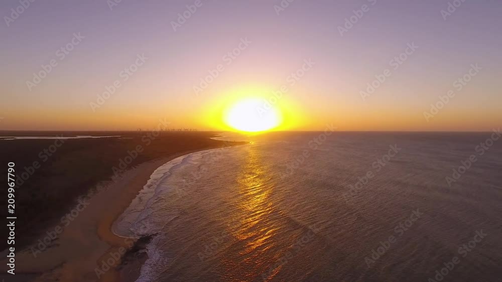 Beautiful blazing sunset landscape at black sea and orange sky above it with awesome sun golden reflection on calm waves as a background. Amazing summer sunset view on the beach. Brazilian nature Beautiful blazing sunset landscape at black sea and orange sky above it with awesome sun golden reflection on calm waves as a background. Amazing summer sunset view on the beach. Brazilian nature