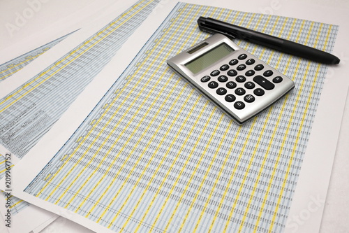 printout paper with calc and pen on desk
