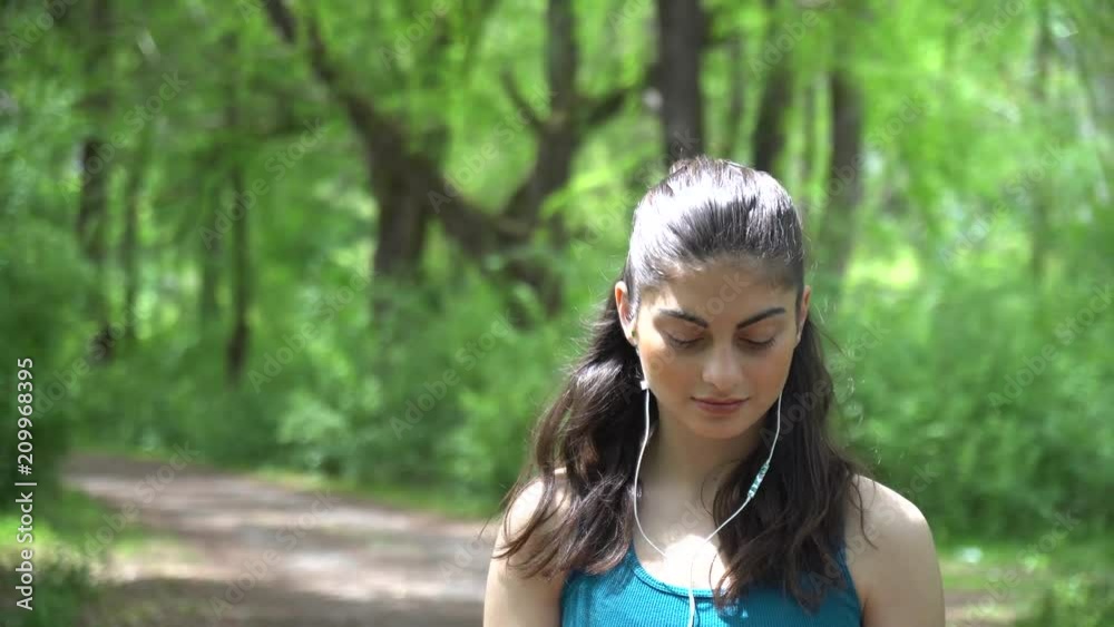 Beautifull sports girl with the phone in the park Beautifull sports girl with the phone in the park