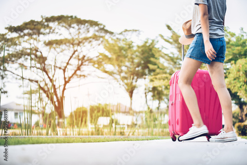 Teenage girls with pink luggage and prepare to travel on vacations.This image is motion blur.