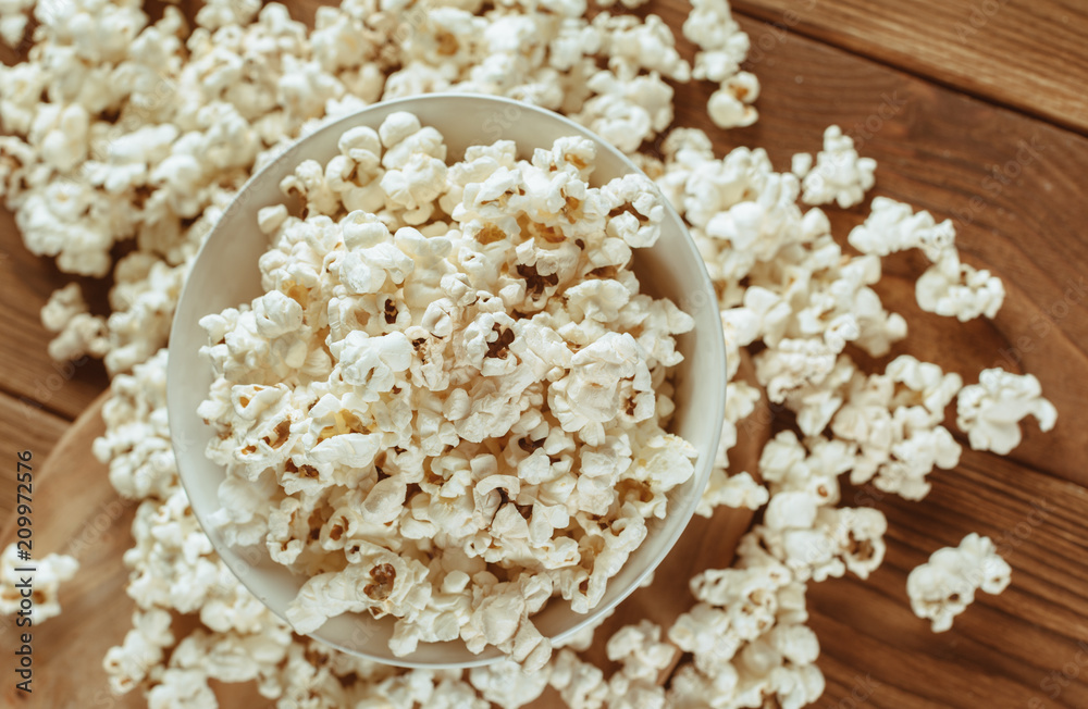 Salt popcorn on the wooden table Salt popcorn on the wooden table