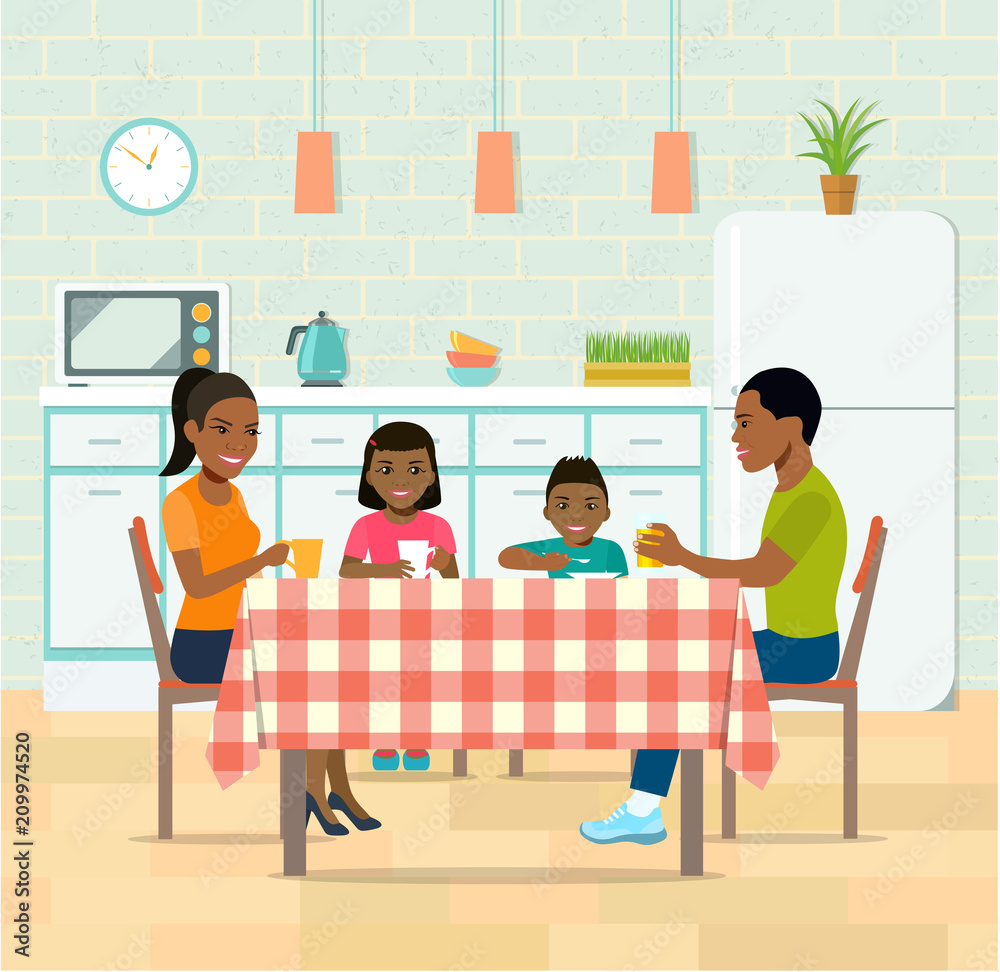 Afro american smiling family having dinner in kitchen.Family drinks tea