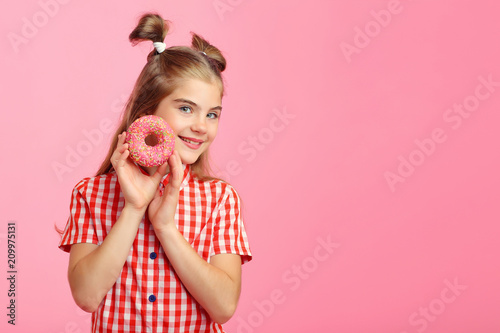 Girl with donuts on a pink background.