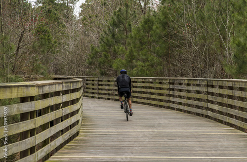 Cycling on a wooden pathway in the forest
